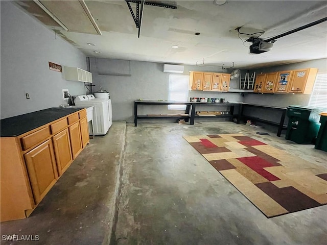 garage with washing machine and dryer and a garage door opener