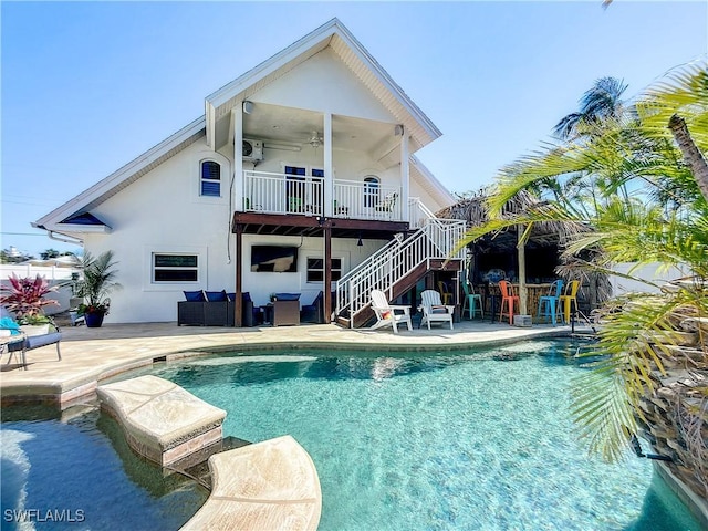 309 Donora Blvd, Fort Myers Beach, FL 33931 - back of house featuring an outdoor pool, stairway, an outdoor bar, and stucco siding