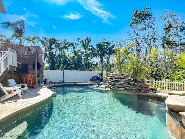 309 Donora Blvd, Fort Myers Beach, FL 33931 - view of swimming pool featuring a fenced in pool, fence private yard, a patio, and exterior bar