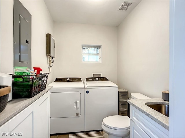 309 Donora Blvd, Fort Myers Beach, FL 33931 - bathroom featuring washer and clothes dryer, visible vents, toilet, vanity, and electric panel