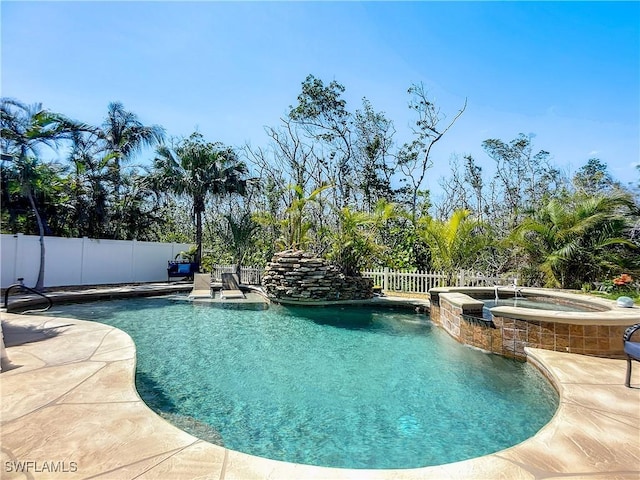 309 Donora Blvd, Fort Myers Beach, FL 33931 - view of pool featuring a patio area, a fenced backyard, and a pool with connected hot tub