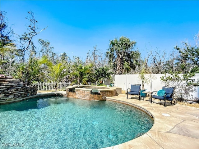 309 Donora Blvd, Fort Myers Beach, FL 33931 - view of pool featuring a pool with connected hot tub, a fenced backyard, and a patio