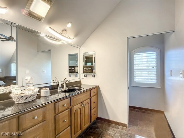 309 Donora Blvd, Fort Myers Beach, FL 33931 - bathroom with ceiling fan, visible vents, vanity, vaulted ceiling, and baseboards