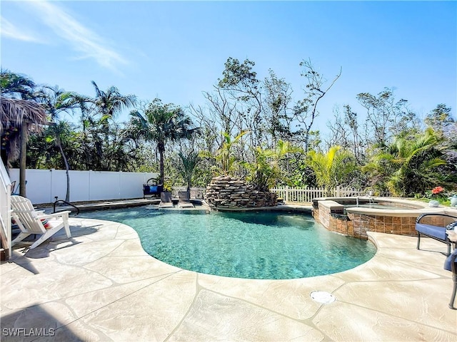 309 Donora Blvd, Fort Myers Beach, FL 33931 - view of swimming pool with a patio area, a fenced backyard, and a pool with connected hot tub
