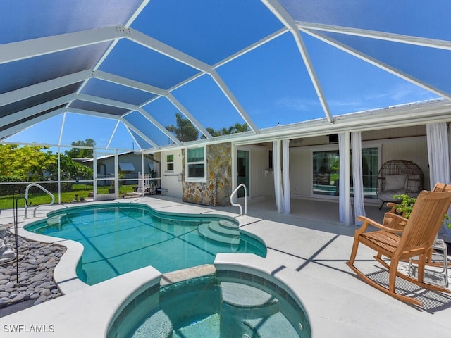 view of pool with glass enclosure, an in ground hot tub, and a patio