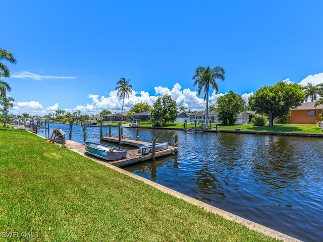 dock area featuring a lawn and a water view