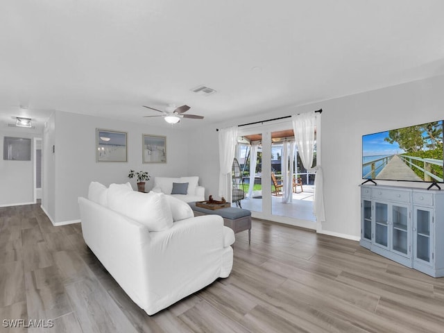 living room featuring ceiling fan and wood-type flooring