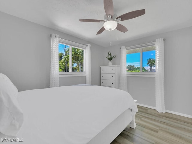 bedroom with ceiling fan and light hardwood / wood-style floors