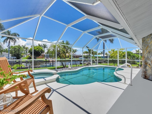 view of swimming pool with an in ground hot tub, a water view, glass enclosure, and a patio area