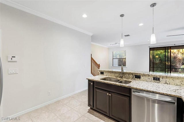 kitchen featuring baseboards, ornamental molding, decorative light fixtures, stainless steel dishwasher, and a sink