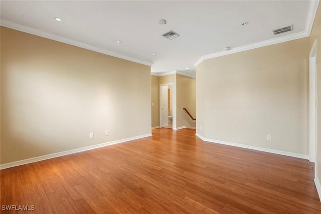 spare room with baseboards, visible vents, and light wood-style floors