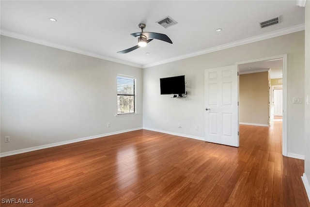 empty room with ceiling fan, baseboards, wood finished floors, visible vents, and ornamental molding