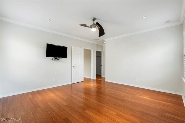 empty room with light wood-style floors, ceiling fan, baseboards, and ornamental molding