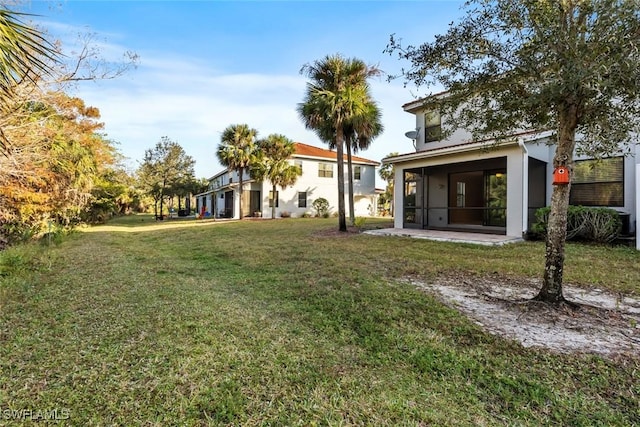 back of property with a lawn and a sunroom