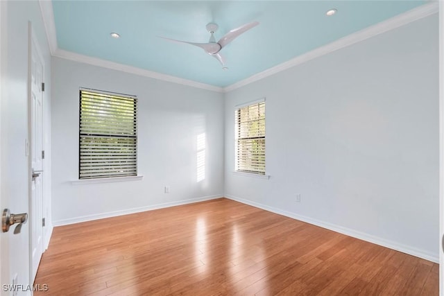 empty room featuring baseboards, ceiling fan, wood finished floors, crown molding, and recessed lighting