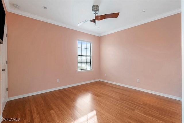 spare room featuring light wood-type flooring, ceiling fan, ornamental molding, and baseboards