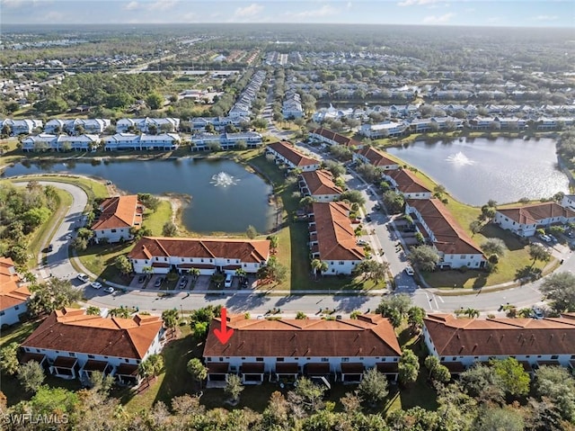 drone / aerial view featuring a water view and a residential view