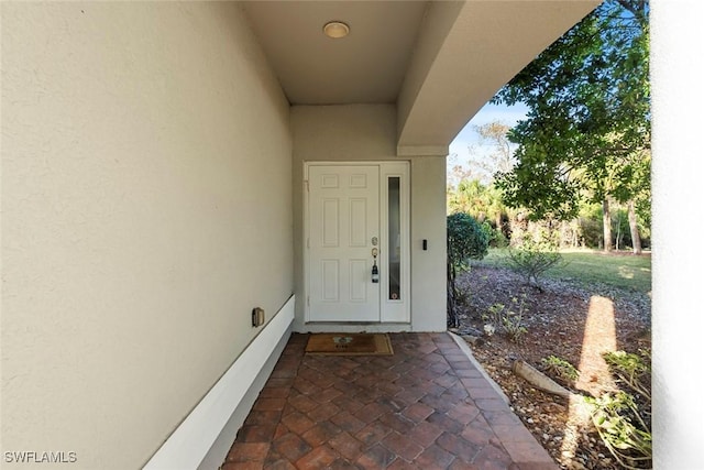 doorway to property with stucco siding