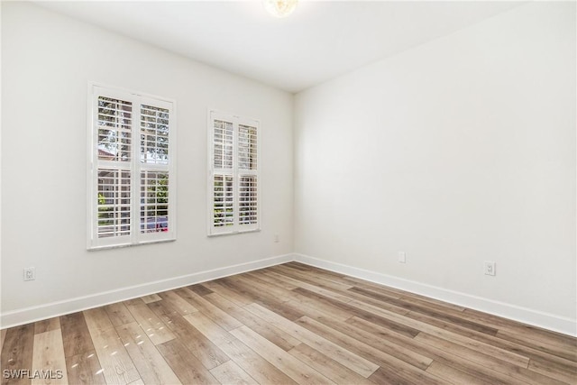 spare room with hardwood / wood-style flooring