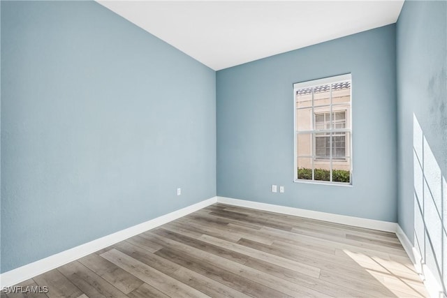 spare room with light wood-type flooring