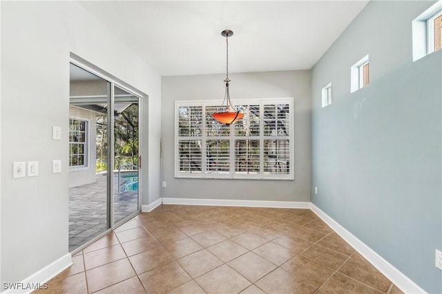 unfurnished dining area featuring tile patterned floors and a healthy amount of sunlight