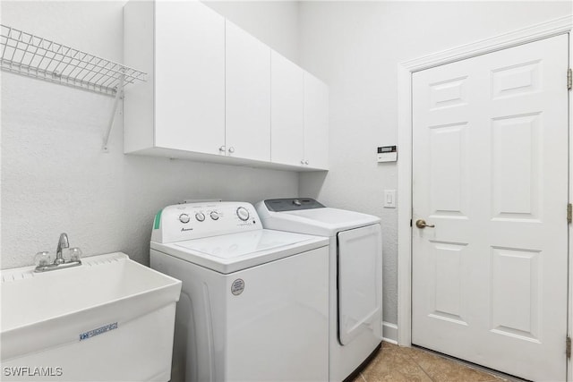 laundry room featuring cabinets, independent washer and dryer, light tile patterned flooring, and sink