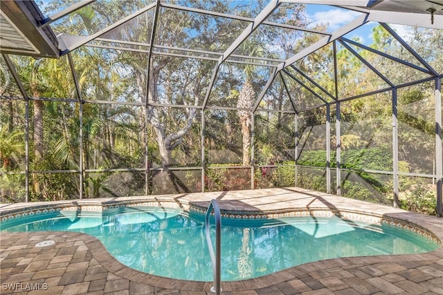 view of swimming pool with a lanai and a patio