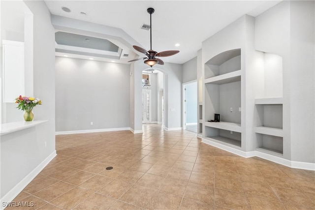 unfurnished living room with built in shelves, ceiling fan, and light tile patterned flooring