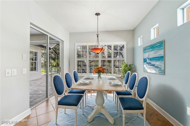 tiled dining space featuring plenty of natural light