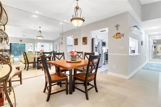 dining space with ceiling fan and lofted ceiling