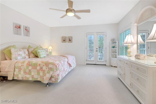 carpeted bedroom featuring french doors, access to outside, and ceiling fan