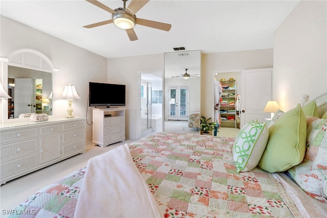 bedroom with ceiling fan and light carpet