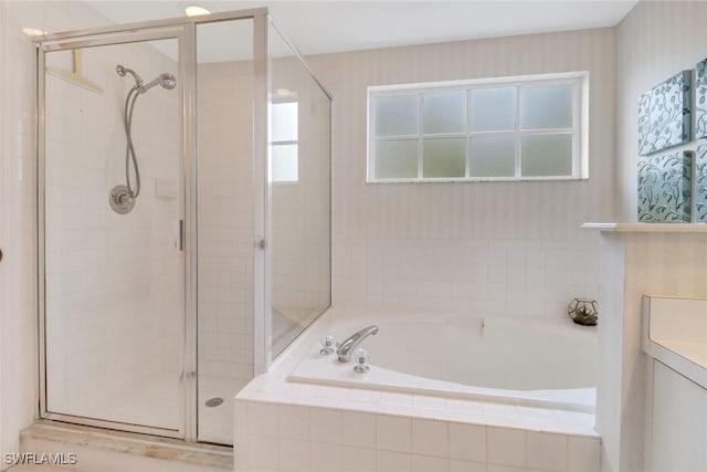 bathroom featuring vanity and shower with separate bathtub