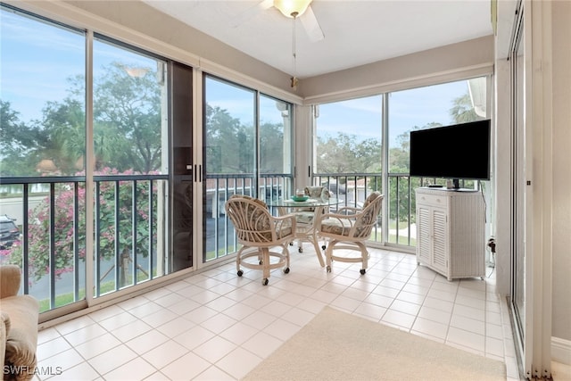 sunroom / solarium featuring ceiling fan