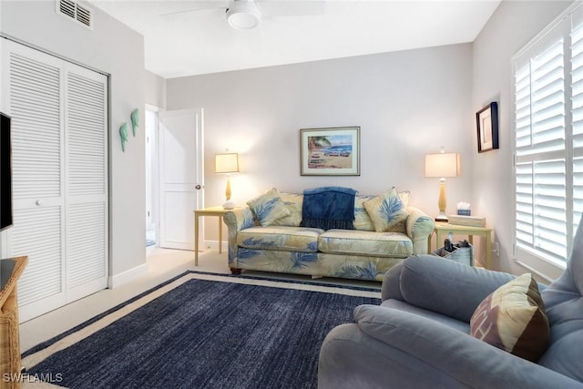 carpeted living room featuring ceiling fan