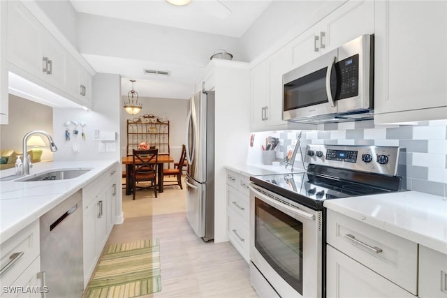 kitchen featuring white cabinetry and appliances with stainless steel finishes