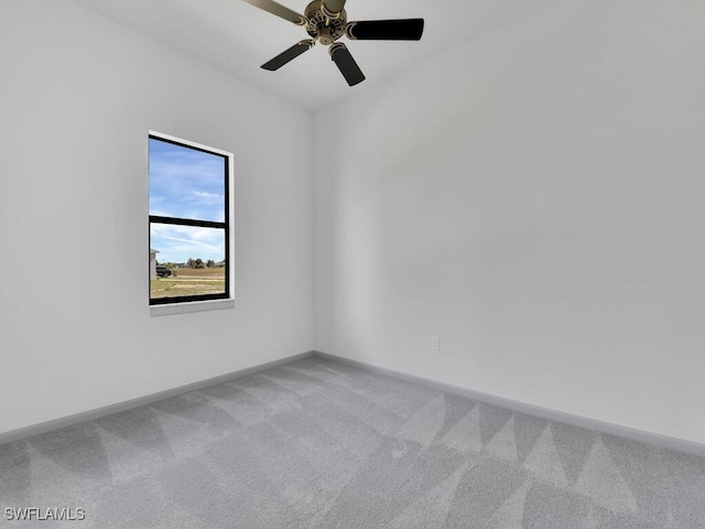 spare room with ceiling fan and light colored carpet