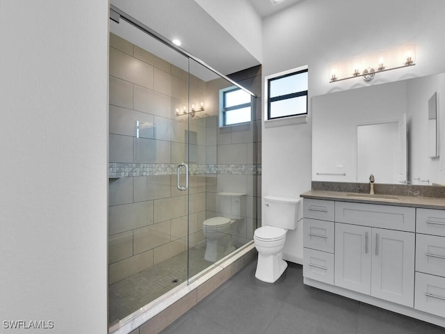 bathroom with vanity, a shower with shower door, tile patterned floors, and toilet