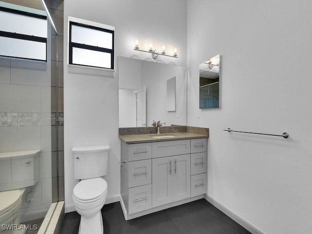 bathroom with vanity, tile patterned flooring, a shower, and toilet