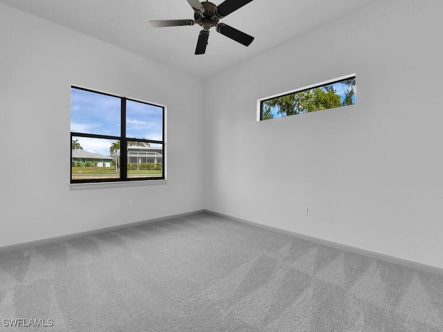 carpeted spare room with ceiling fan