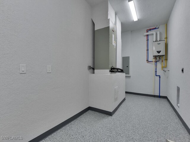 hall with water heater and electric panel