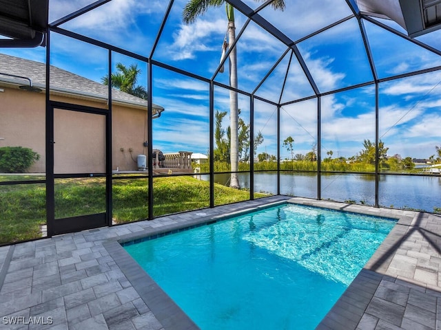 view of swimming pool featuring a water view, glass enclosure, and a patio area