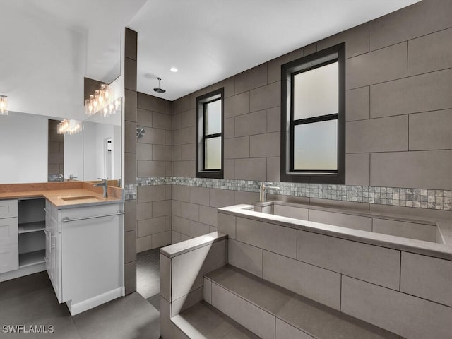 bathroom featuring vanity, tile walls, and a shower