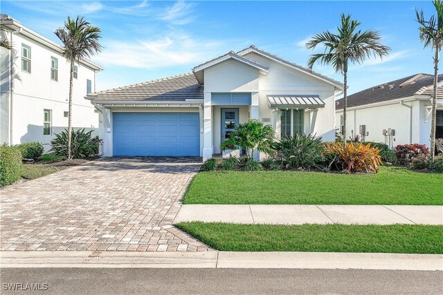 view of front of home with a garage and a front yard