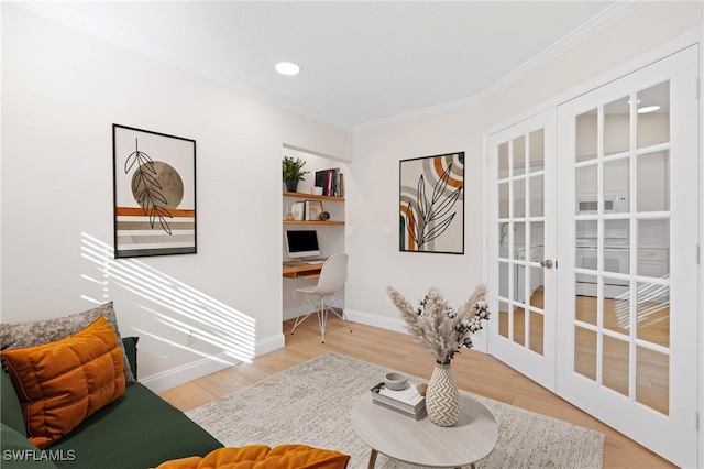 living area with french doors, light wood-type flooring, and crown molding