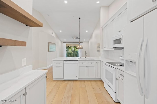 kitchen featuring ceiling fan, sink, pendant lighting, white appliances, and white cabinets