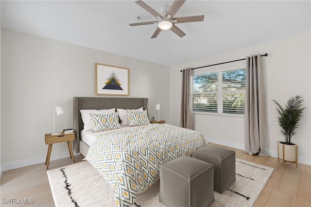 bedroom with light hardwood / wood-style flooring and ceiling fan