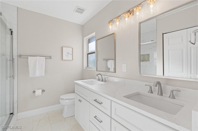 bathroom featuring toilet, vanity, and walk in shower