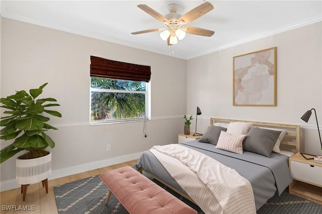 bedroom featuring light hardwood / wood-style flooring, ceiling fan, and crown molding