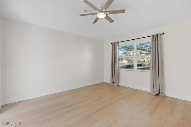 empty room with ceiling fan and light hardwood / wood-style floors